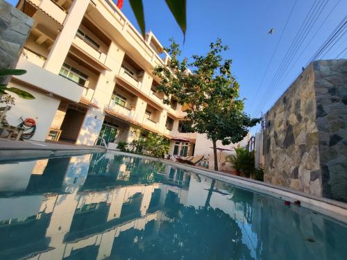 a swimming pool in front of a building at Casa Puerto Bonito, Aparthotel & Coworking in Puerto Escondido