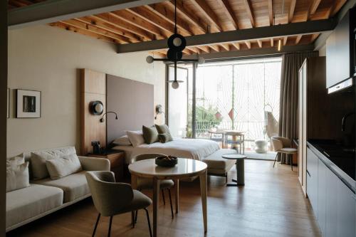 a living room with a couch and a table at Colima 71 - Casa de Arte Hotel in Mexico City