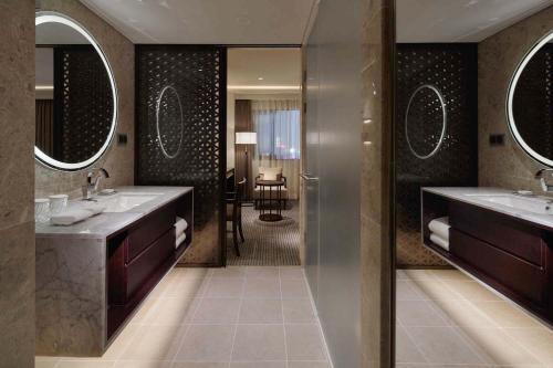 a bathroom with two sinks and two mirrors at Royal Hotel Seoul in Seoul