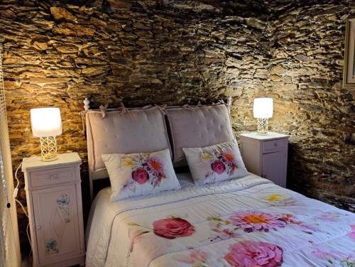 a bedroom with a bed with flowers on it at Casa da Vita in Ferreira