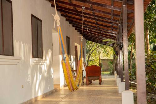 a hallway with surfboards hanging from a building at El Bosque Hotel in Copán Ruinas