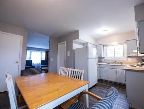 a kitchen with a wooden table and a white refrigerator at Cheerful home with free parking and WiFi in Rochester