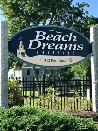 a sign for a beach dreams clubhouse in front of a fence at Private and Peaceful 2-Bedroom Cottage on Resort close to the beach! in Wells