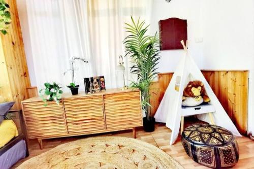 a room with a bed and a dresser with plants at Central Parkside 5BR Home with Rumpus & King Bed in Chadstone