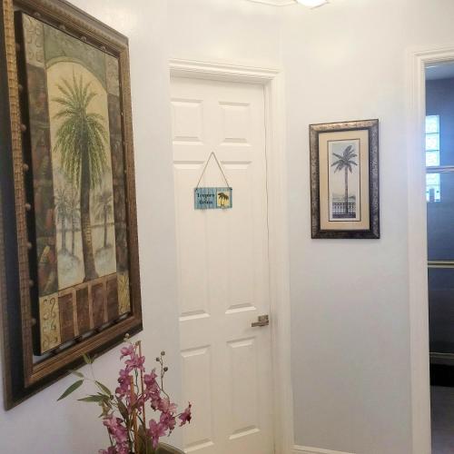 a white door in a room with a picture on the wall at Cape Paradise B & B - Your Luxury Tropical Retreat in Cape Coral