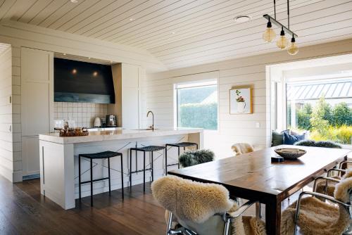 a kitchen and dining room with a table and chairs at Craggy Range Luxury Vineyard Retreat in Havelock North