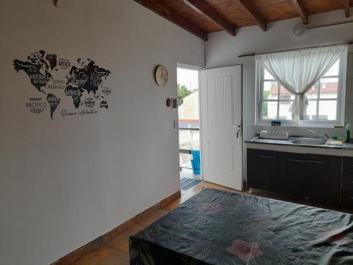 a kitchen with a map of the world on the wall at Departemento Solumi Relax in San Bernardo