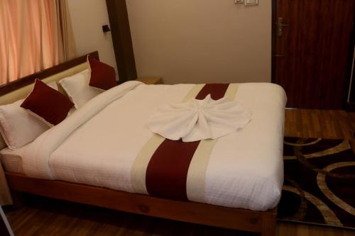 a bedroom with a bed with a bow on it at Hotel Family Ties Pvt. Ltd. in Kathmandu