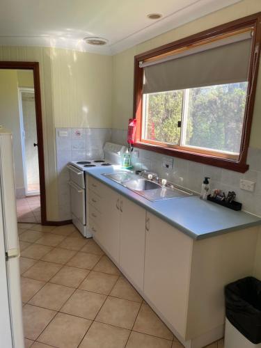 uma cozinha com um lavatório e uma janela em Sandy Hollow Tourist Retreat em Sandy Hollow