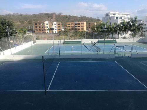 a tennis court with two tennis rackets on it at Apartment (Grand Diamond Beach) Tonsupa in Tonsupa