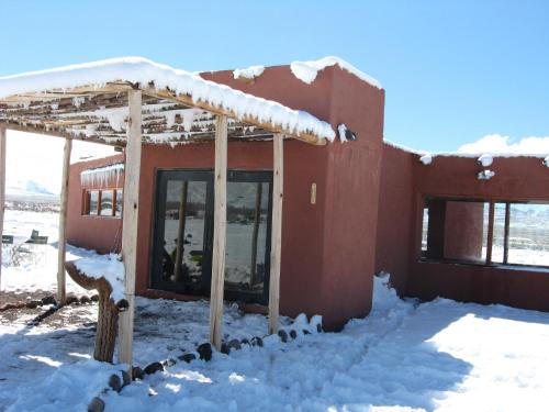 a building covered in snow with snow on it at Hotel boutique Pukarainca in Uspallata