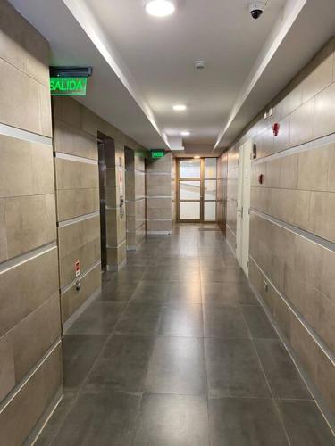 a hallway in a building with a sign on the wall at Acogedor Departamento estudio en centro de Chillán in Chillán