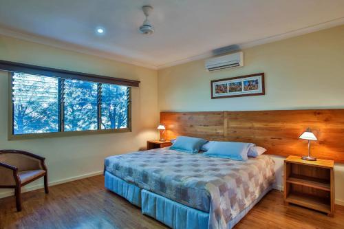 a bedroom with a bed and a television at Kimberley Hotel in Halls Creek