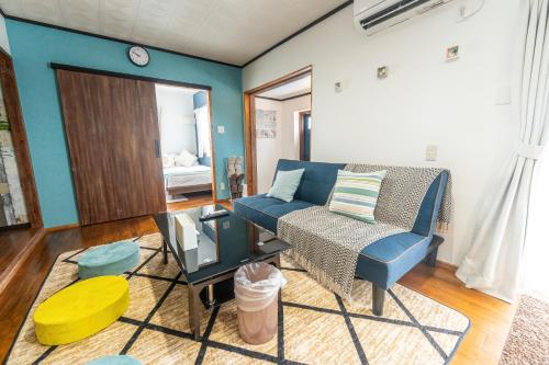 a living room with a couch and a table at private house noko in Miyako Island