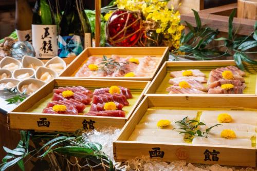 three wooden boxes filled with different types of food at HAKODATE Uminokaze in Hakodate