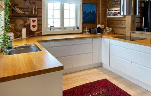 a kitchen with white cabinets and a sink at Lovely Home In Sykkylven With House A Panoramic View in Sykkylven