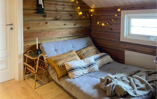 a bed in a room with a wooden wall at Lovely Home In Sykkylven With House A Panoramic View in Sykkylven