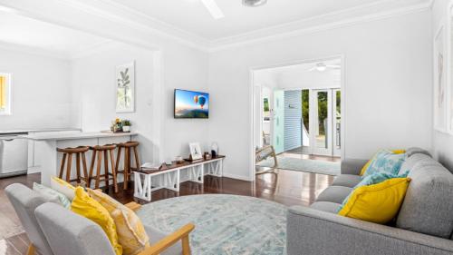 a living room with a couch and a table at The Blue Beachside Bungalow in Woorim