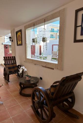a living room with two rocking chairs and a table at Noe Hotel One BedRoom #3 in Punta Cana