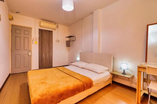 a bedroom with a large bed in a room at Bata Merah Boutique Hotel in Banting