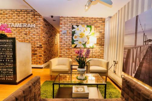 a living room with a table and chairs at Bata Merah Boutique Hotel in Banting