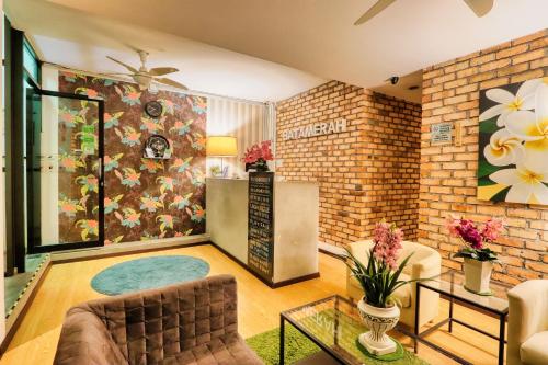 a living room with a couch and a table at Bata Merah Boutique Hotel in Banting