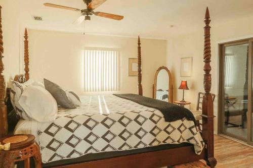 een slaapkamer met een bed en een plafondventilator bij Admiral Suite in St. Augustine