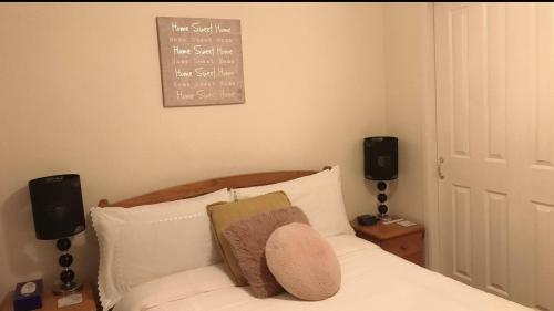 a bedroom with a bed with two speakers at Comfy Home in Aberdeen
