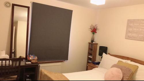 a bedroom with a large chalkboard on the wall at Comfy Home in Aberdeen