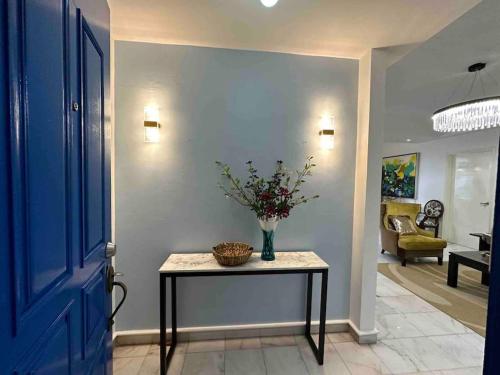 a hallway with a table with a vase of flowers on it at Cosy City Centre Living at WTC in Kuala Lumpur