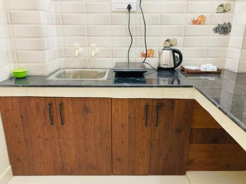 a kitchen with a sink and a counter top at The Lavish Stay in Varanasi