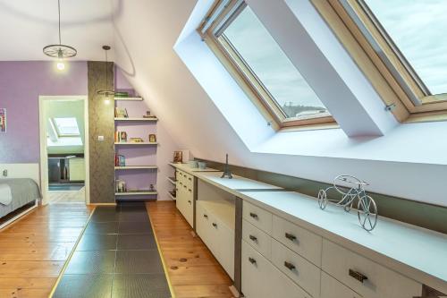 a attic kitchen with skylights and white cabinets at Zen Home pLOVEdiv in Plovdiv