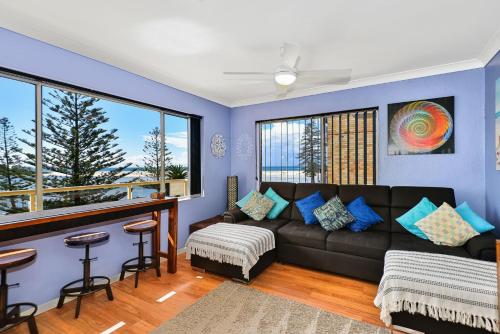 a living room with a couch and a table at Sandhurst 5 in The Entrance