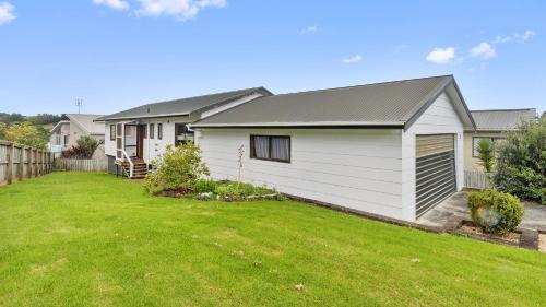 a house with a yard in front of it at Crystal Clear - Snells Beach Holiday Home in Snells Beach