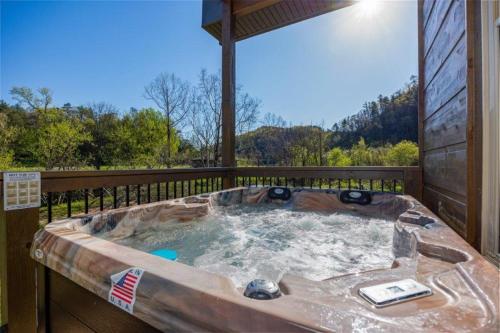 a hot tub on the deck of a house at Creekside Splendor cabin in Sevierville