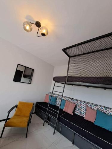 a room with two bunk beds and a chair at Seaside Dream in Thessaloniki