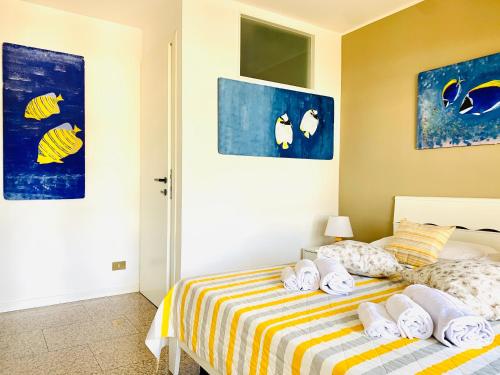 1 dormitorio con 1 cama con toallas en Beach House Riviera en Lignano Sabbiadoro