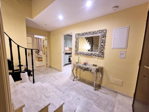 a room with a staircase and a mirror on the wall at Villa Victoria in Marbella