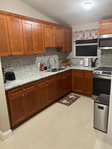 a kitchen with wooden cabinets and a stove top oven at Oak Ridge House in Tampa