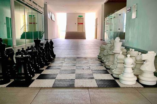 a room with chess pieces on the floor of a building at Festival Walk homestay,13min to Tambun Lost World in Ipoh