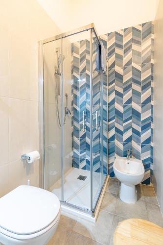 a bathroom with a shower and a toilet and a sink at Agriturismo Casa Marmida in Pardu Atzei