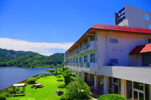 a building with a view of a body of water at glampark Kameyama Onsen Chiba in Tabuchi