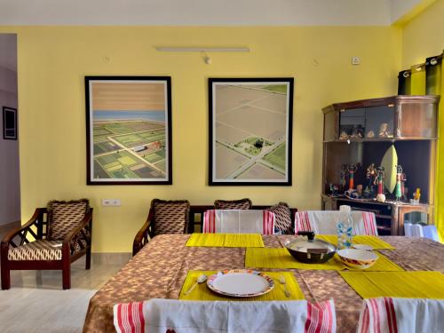 a dining room with a table and chairs at Three Little Birds Homestay in Guwahati