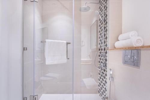a bathroom with a shower with a glass door at Host and Stay - Collective tower 1, Dubai Hills Estate in Dubai