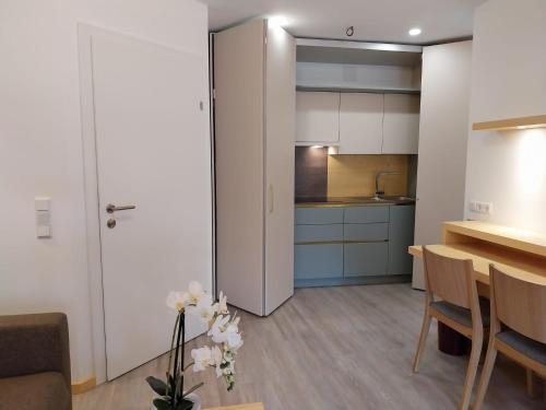 a living room with a table and a kitchen at Hotel Post Hönigwirt in Kirchschlag