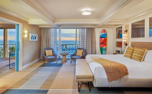 a hotel room with a bed and a view of the ocean at Viceroy Santa Monica in Los Angeles