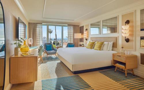 a hotel room with a bed and a view of the city at Viceroy Santa Monica in Los Angeles