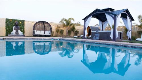 a swimming pool with a gazebo and a swimming pool at Buddha Mansion Luxury Resort - 8BR Modern, HotTub, Huge pool, Sauna, BBQ grill, Game Room in Las Vegas