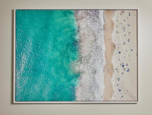an overhead picture of the beach with people on the shore at Viceroy Santa Monica in Los Angeles