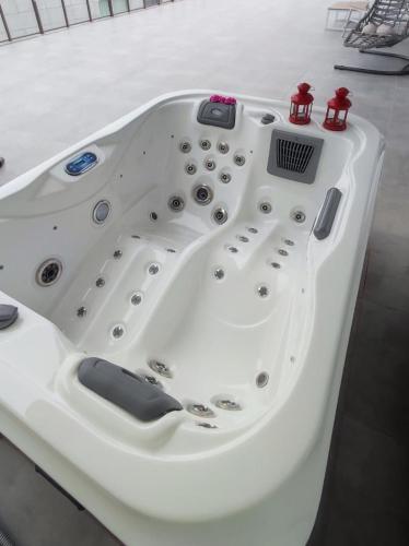 a white bath tub sitting in a room at Courtyard Long Beach Holiday Resort in Iskele
